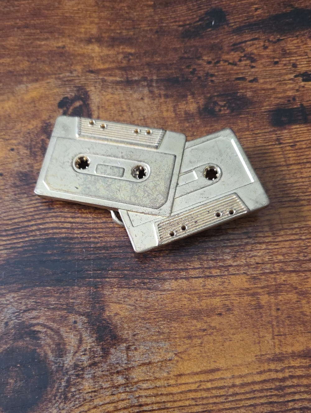 vintage-style cassette tape belt buckles with a metallic gold finish.
